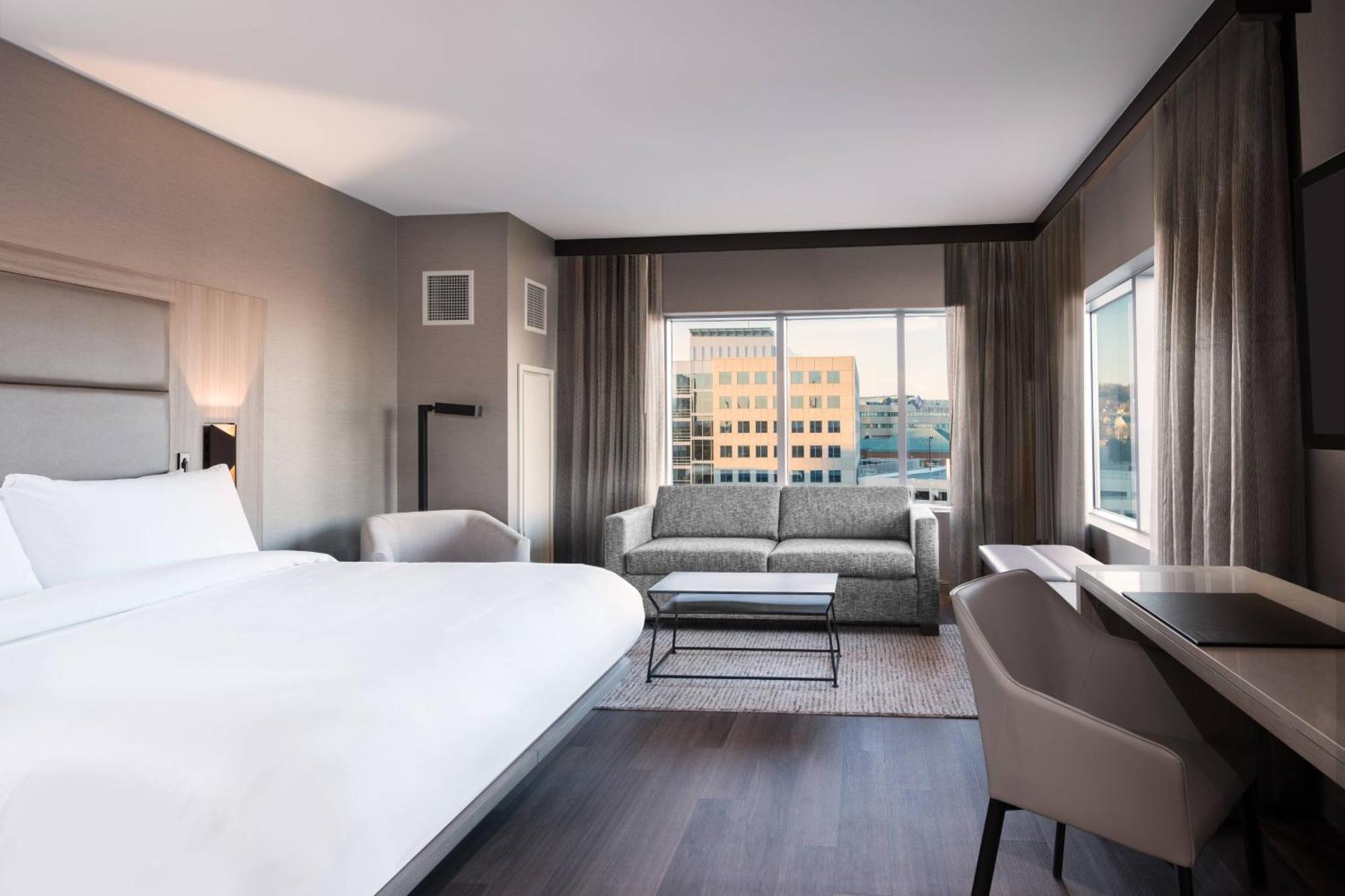 Corner King Guest Room with Sofa Bed and City View