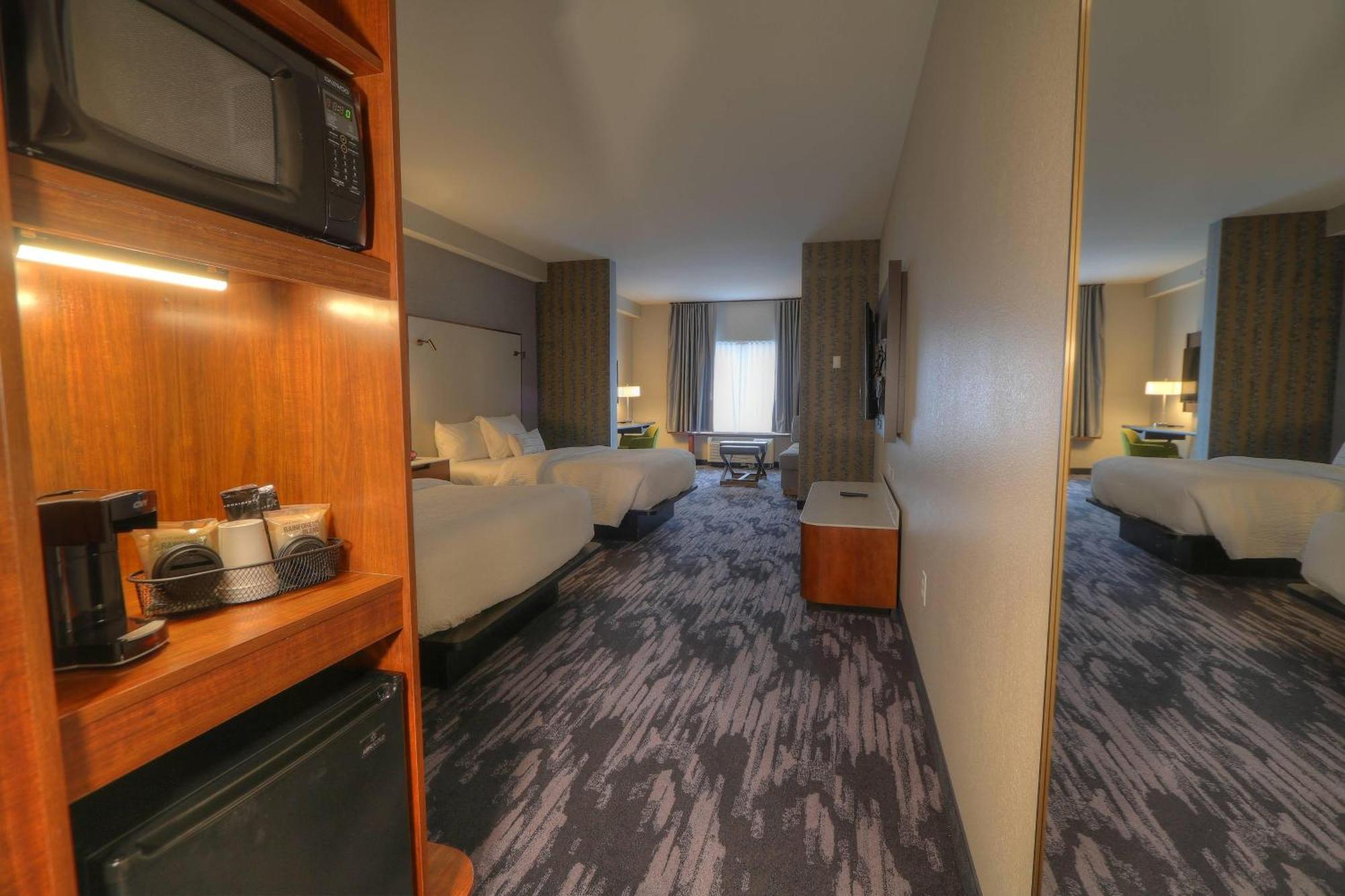 Queen Room with Two Queen Beds, Sitting Area and Sofa Bed